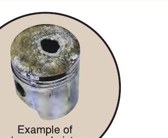 Pre-ignition damage — burned hole through piston caused by extreme overheating